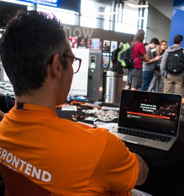 Person looking at a laptop where a livestream is playing of Frontend United